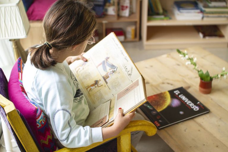 Playing or Working - A girl reading a book at International Montessori School - Sotogrande, Cádiz, Spain