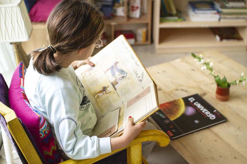 Playing or Working - A girl reading a book at International Montessori School - Sotogrande, Cádiz, Spain
